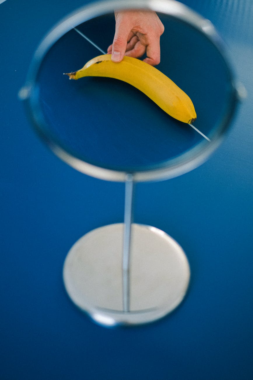 yellow banana fruit on blue surface