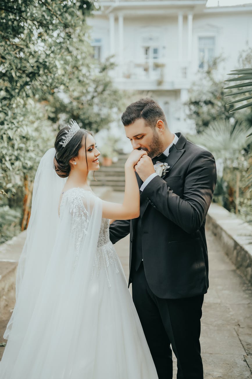 groom kissing brides hand