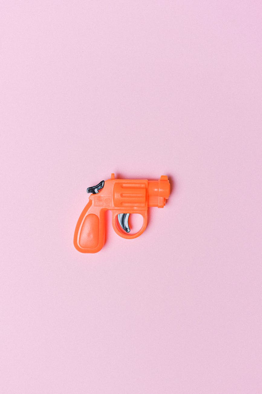 red revolver for game on pink background