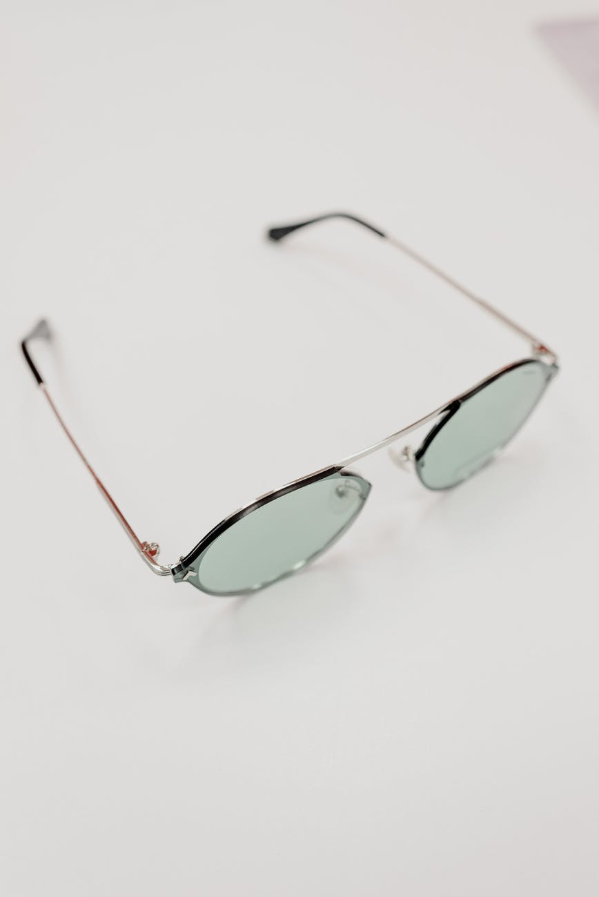 stylish sunglasses placed on white table