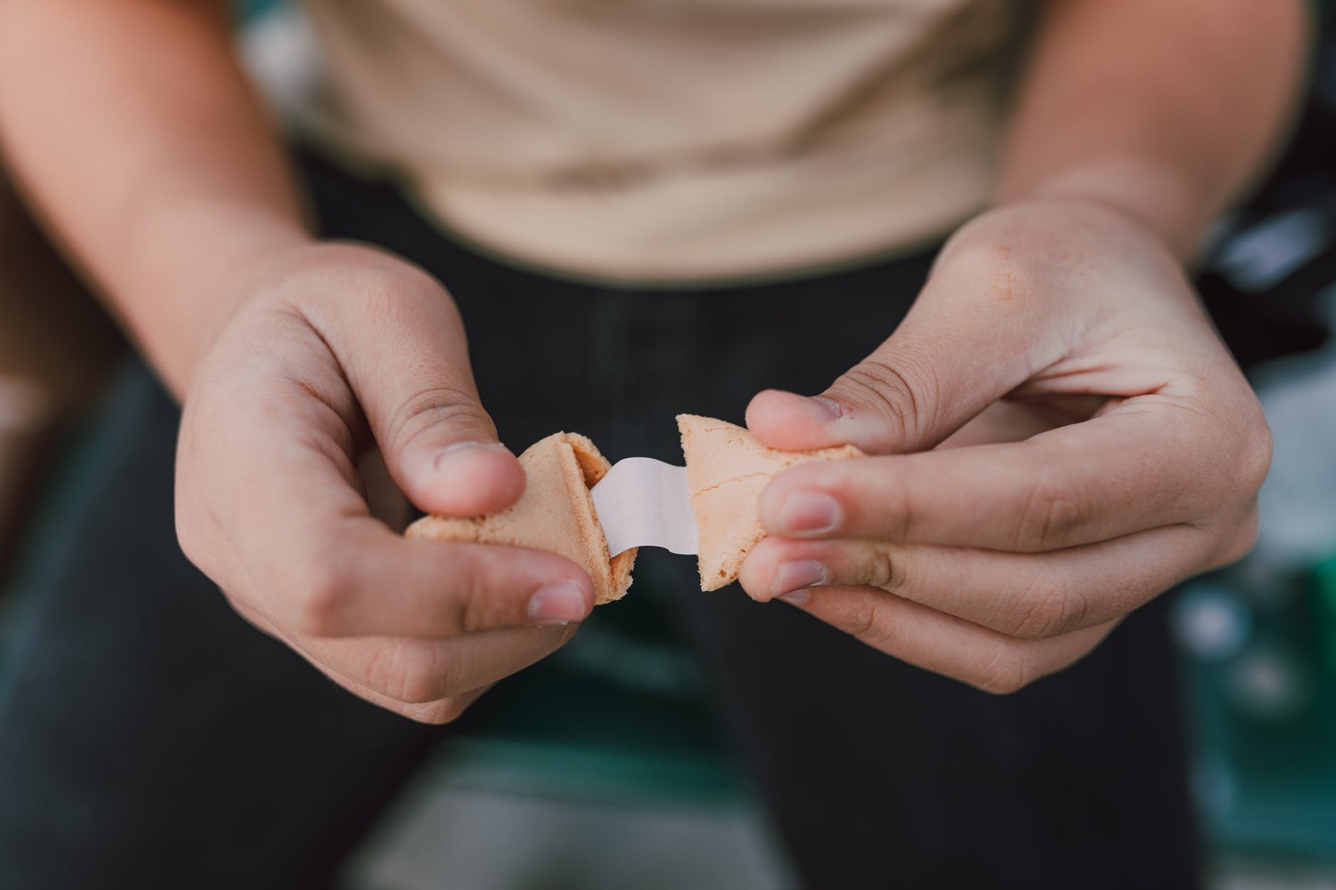 a person holding a fortune cookie