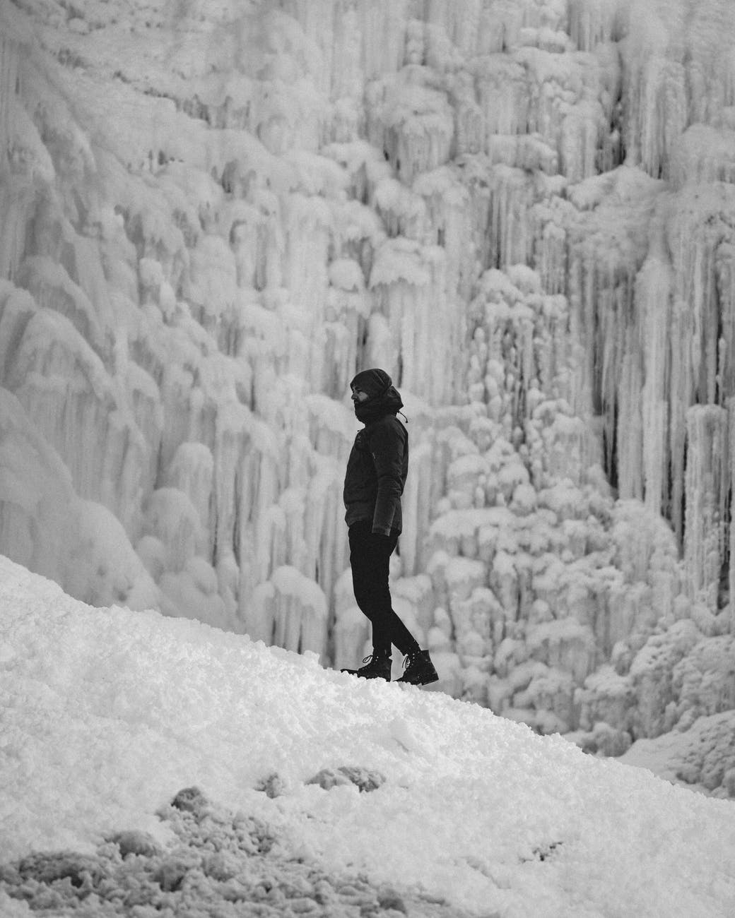 a man hiking on a freezing mountain path
