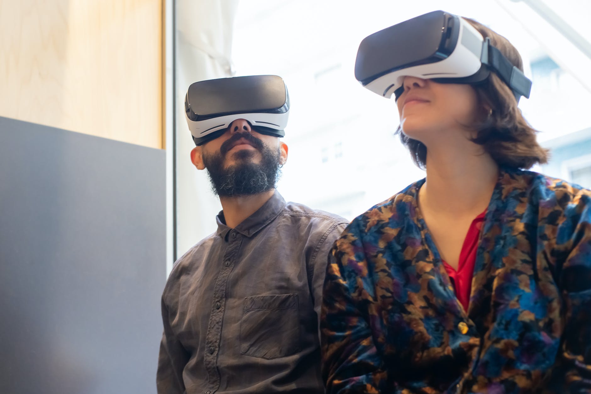 a man and a woman wearing virtual realty gogges