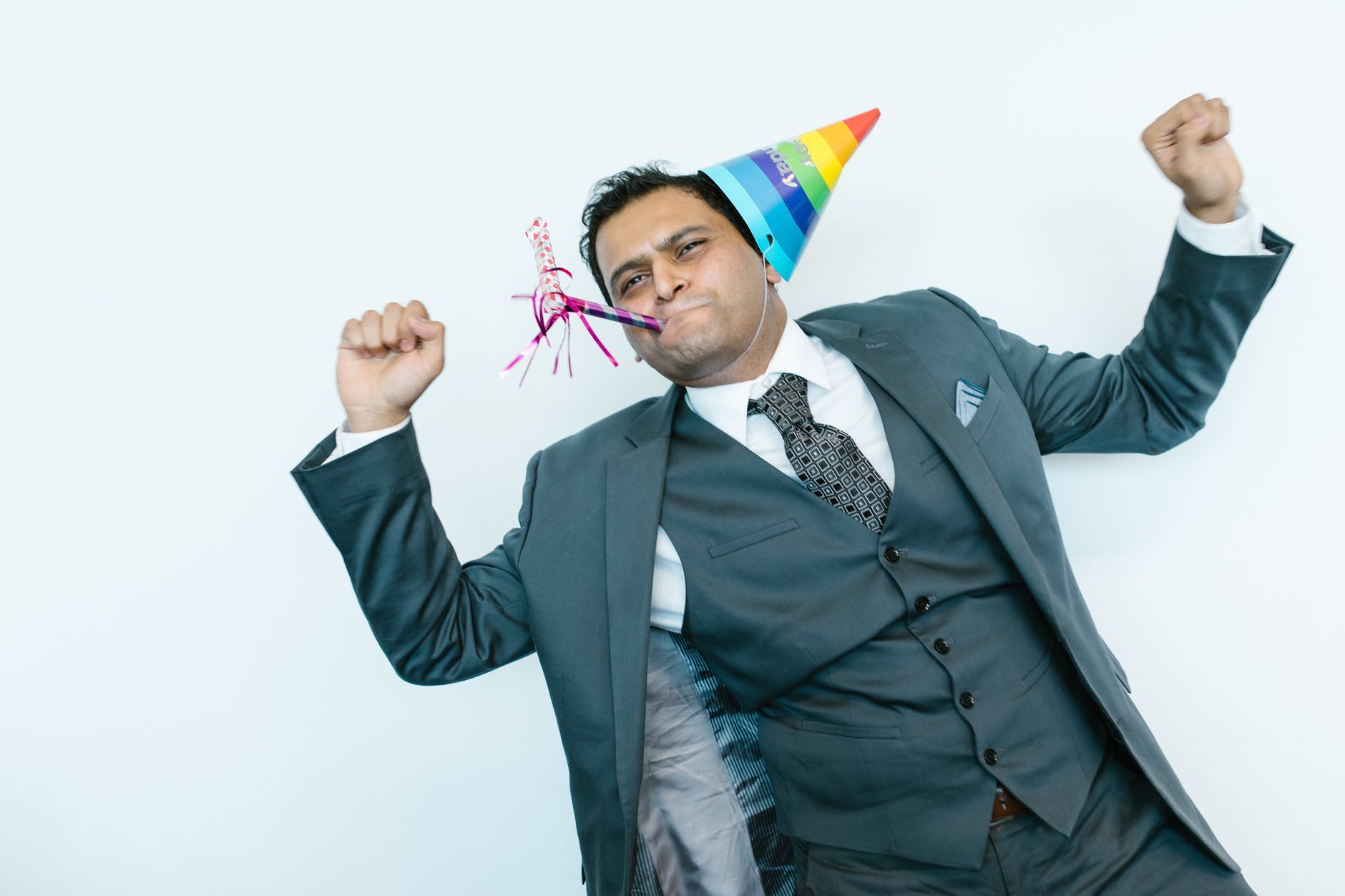 man in suit jacket wearing a party hat