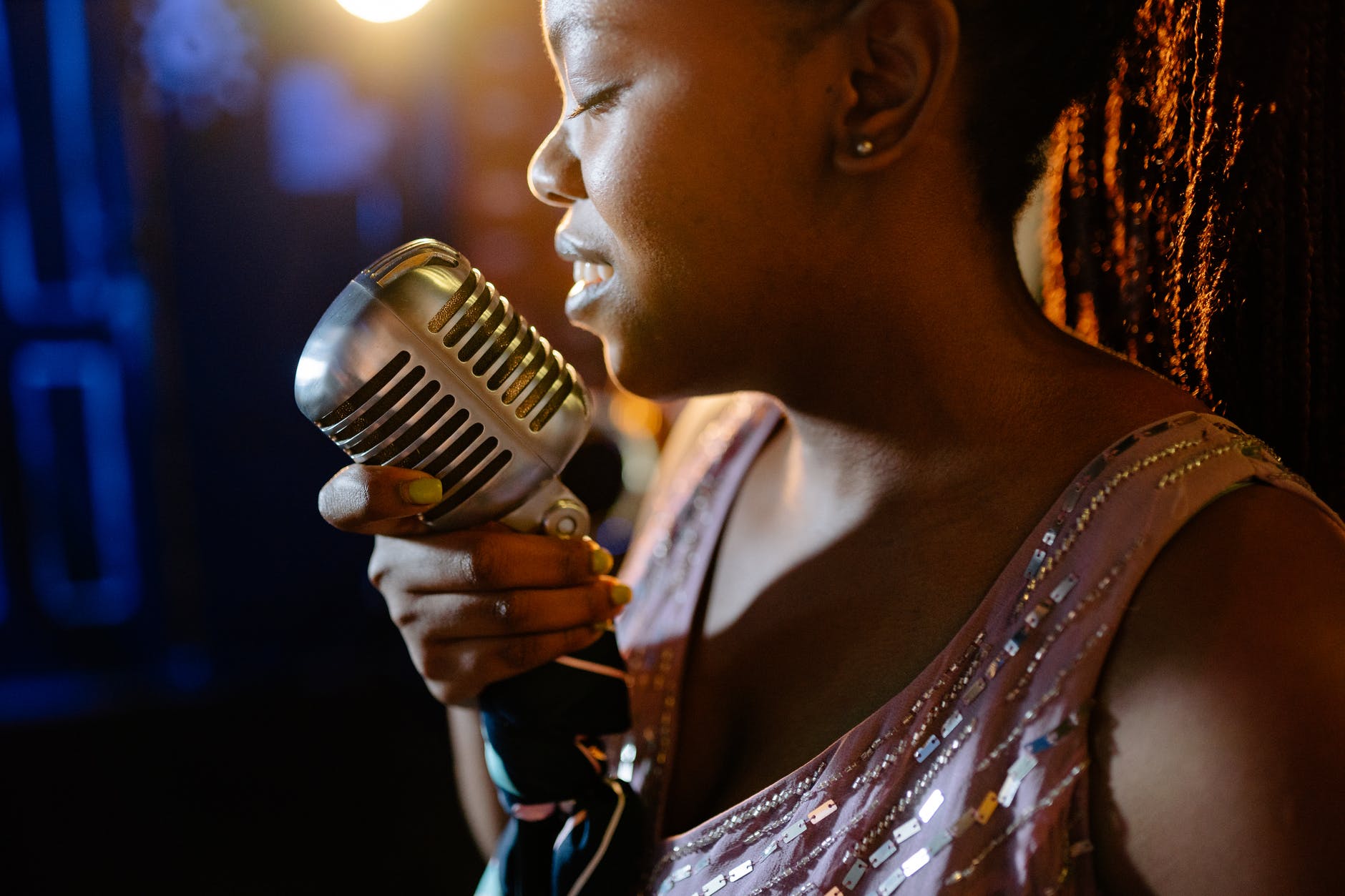 a woman singing while eyes closed