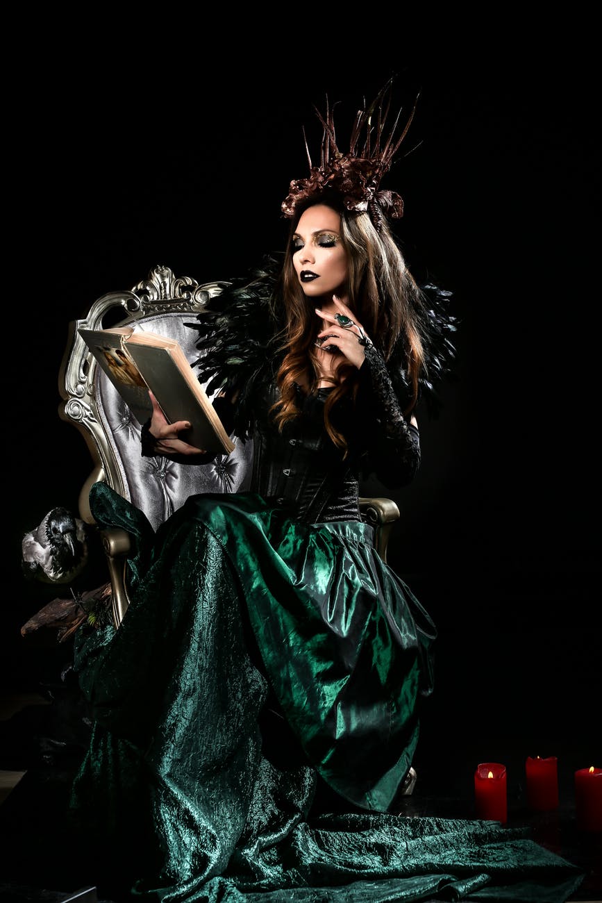 woman in a costume reading a book