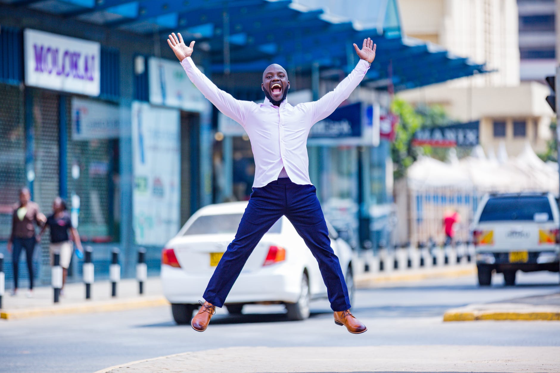 photo of a man jumping on sidewalk