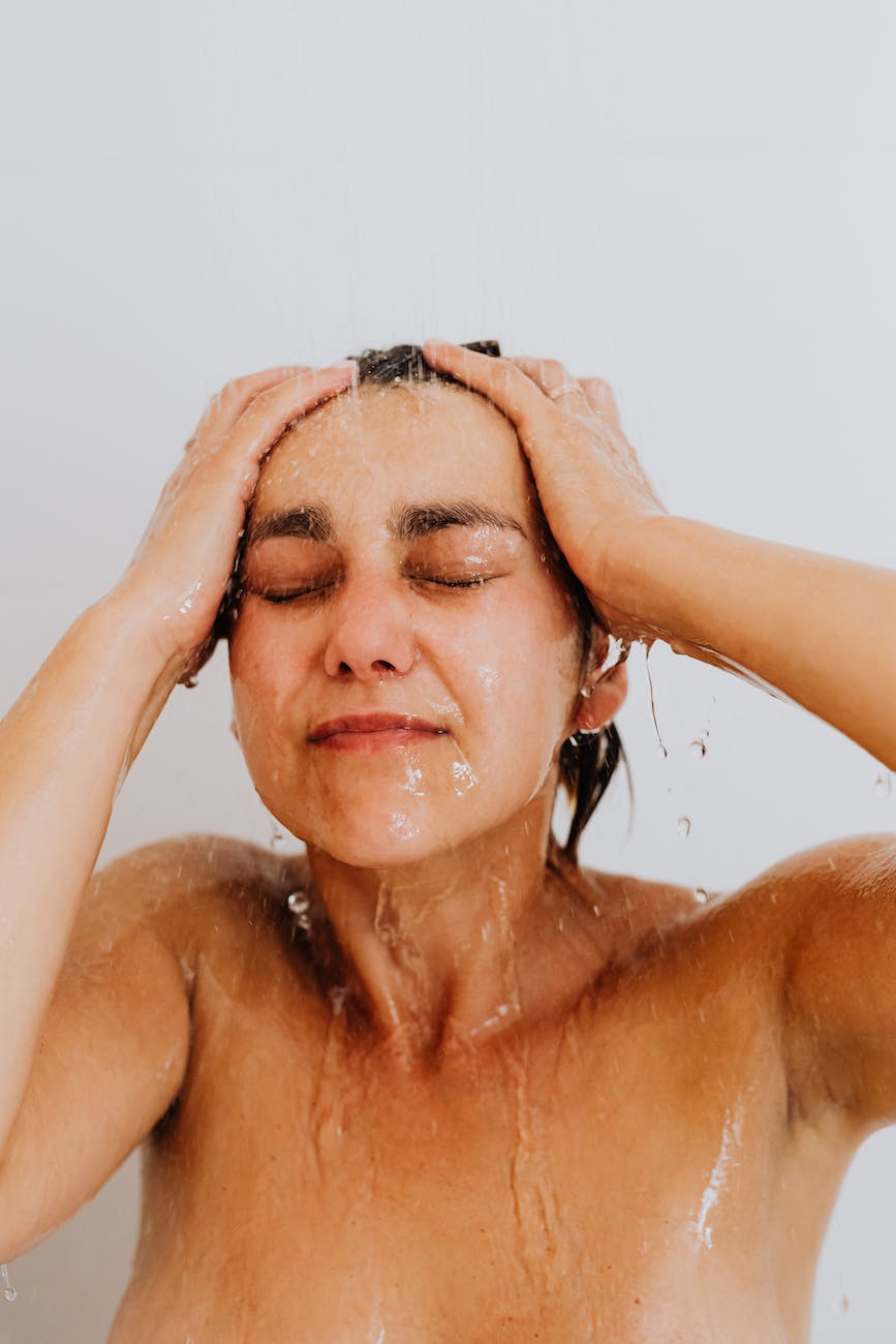 naked woman under water in shower