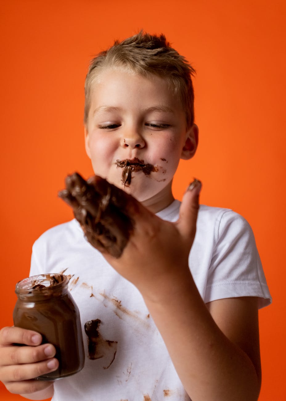photo of boy enjoying melted chocolate