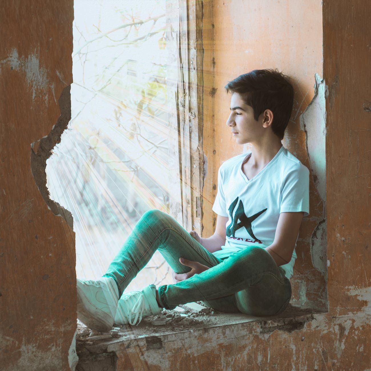 boy sitting near wall